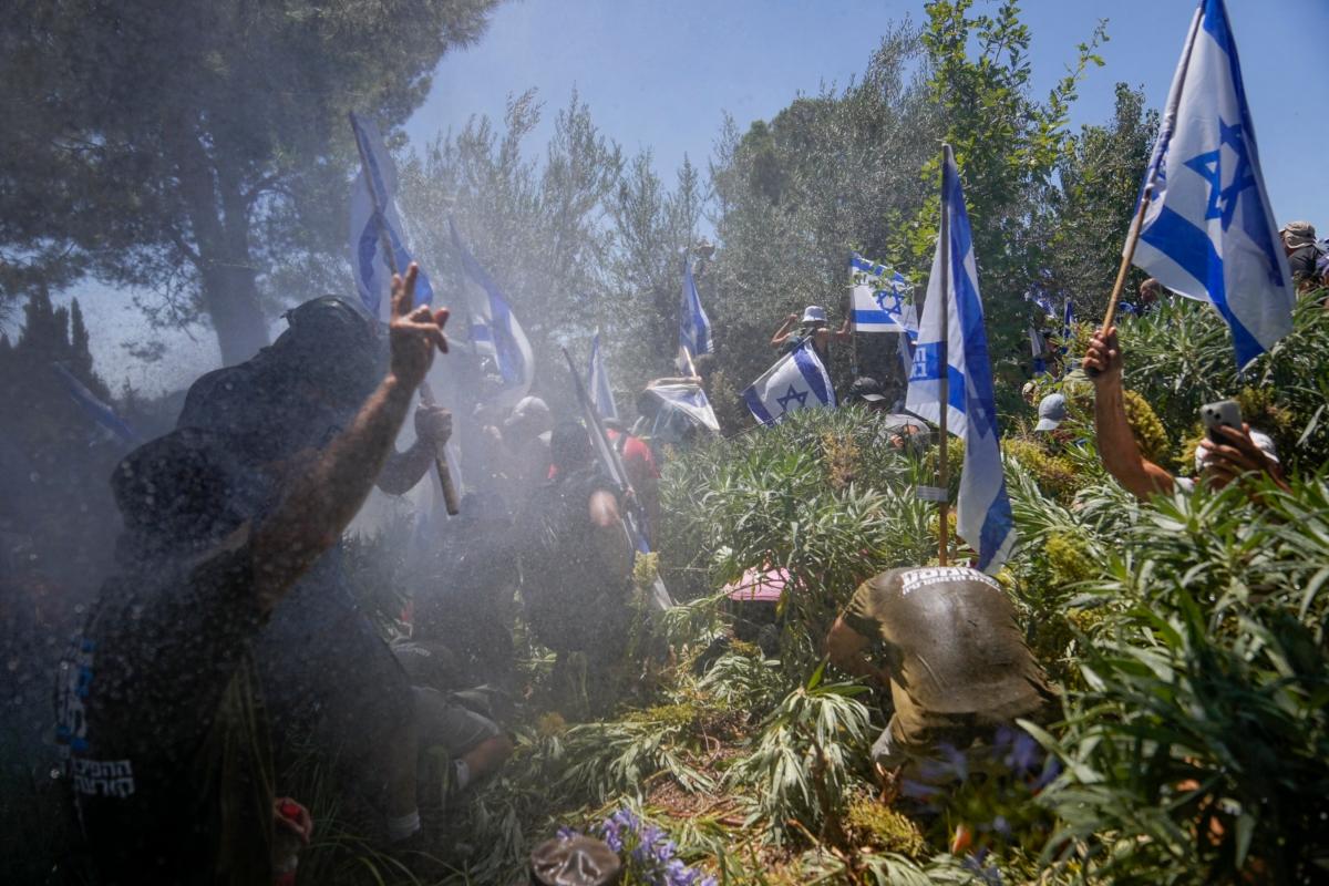 Israeli police use a water cannon to disperse demonstrators during a protest against plans by Prime Minister Benjamin Netanyahu's government to overhaul the judicial system, outside the Knesset, Israel's parliament, in Jerusalem on July 24, 2023. (Ohad Zwigenberg/AP Photo)