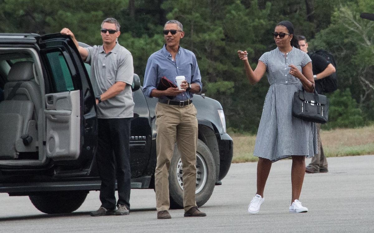U.S. President Barack Obama and First Lady Michelle Obama wait for their daughters Malia and Sasha to board Marine One at Martha's Vineyard airport in Edgartown, Mass., on Aug. 21, 2016. (Nicholas Kamm/AFP via Getty Images)