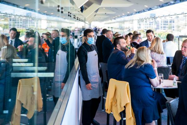 A waiter wears a mask during Bentley Cup Day at Royal Randwick Racecourse in Sydney, Australia, on Nov. 3, 2020. (Jenny Evans/Getty Images)