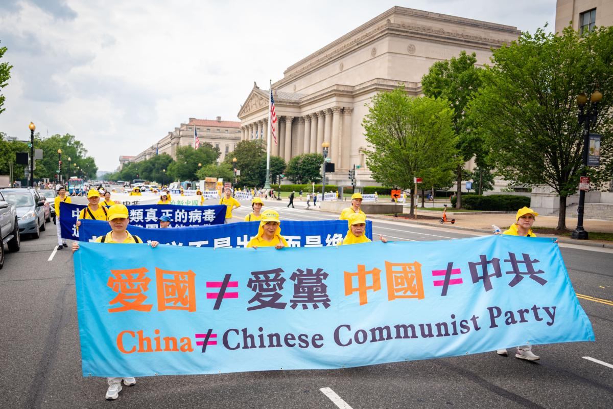 Falun Gong adherents march to mark the 24th anniversary of the Chinese regime’s persecution of the spiritual discipline in Washington, on July 20, 2023. (Samira Bouaou/The Epoch Times)