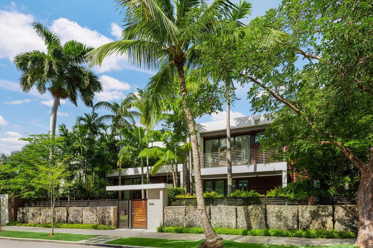 The residence has impressive curb appeal, securely tucked behind a wall of locally sourced limestone. (Courtesy of 1 Oak Studios/ONE Sotheby’s International Realty)