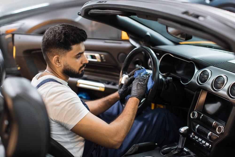 Wipe down the steering wheel, hub, the steering column, control stalks and the instrument panel to remove accumulated dust.(SofikoS/Shutterstock)