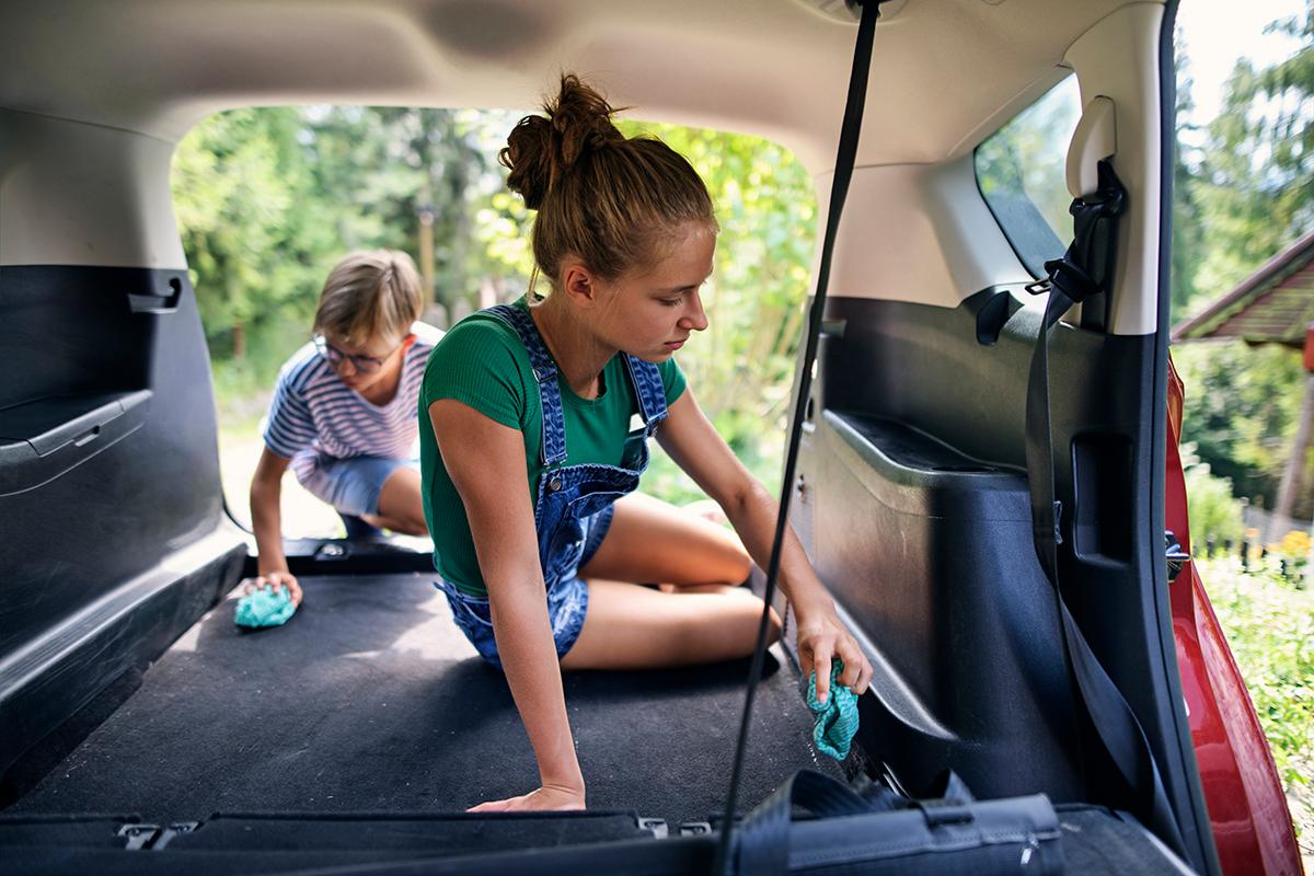Get the whole family involved to make it fun; vacuum the cargo area and storage bins of SUVs to prevent “mystery odors.” (Imgorthand/Getty Images)