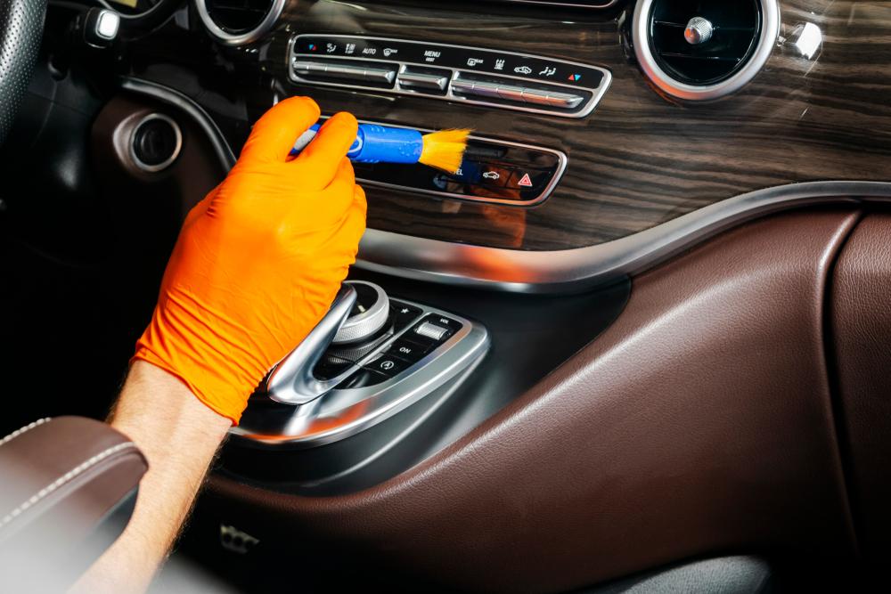 True car aficionados will use a small paint brush to remove dust from A/C vents, stereo control buttons, and other hard-to-reach areas.(BigTunaOnline/Shutterstock)