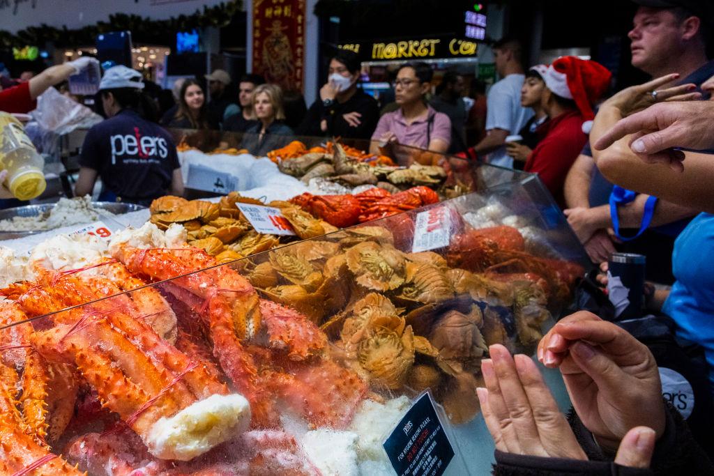 Customers line up to order seafood at Sydney Fish Market in Sydney, Australia, on Dec. 24, 2022. (Jenny Evans/Getty Images)
