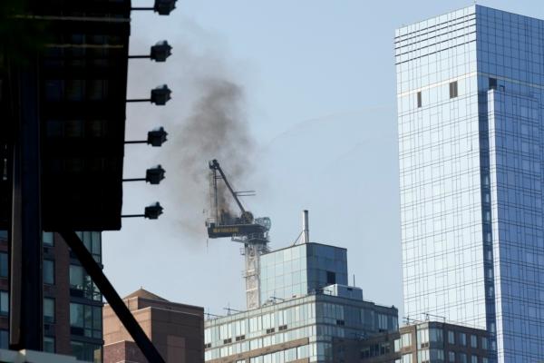 Smoke rises from a construction crane that caught fire in Manhattan, N.Y., on July 26, 2023. (Seth Wenig/AP Photo)