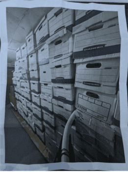 A photo of some of the 61 boxes that federal authorities say were stacked in a storage room at former President Donald Trump's home at Mar-a-Lago in Palm Beach, Fla.. The image was included in a search warrant affidavit. (Janice Hisle/The Epoch Times via screenshot)