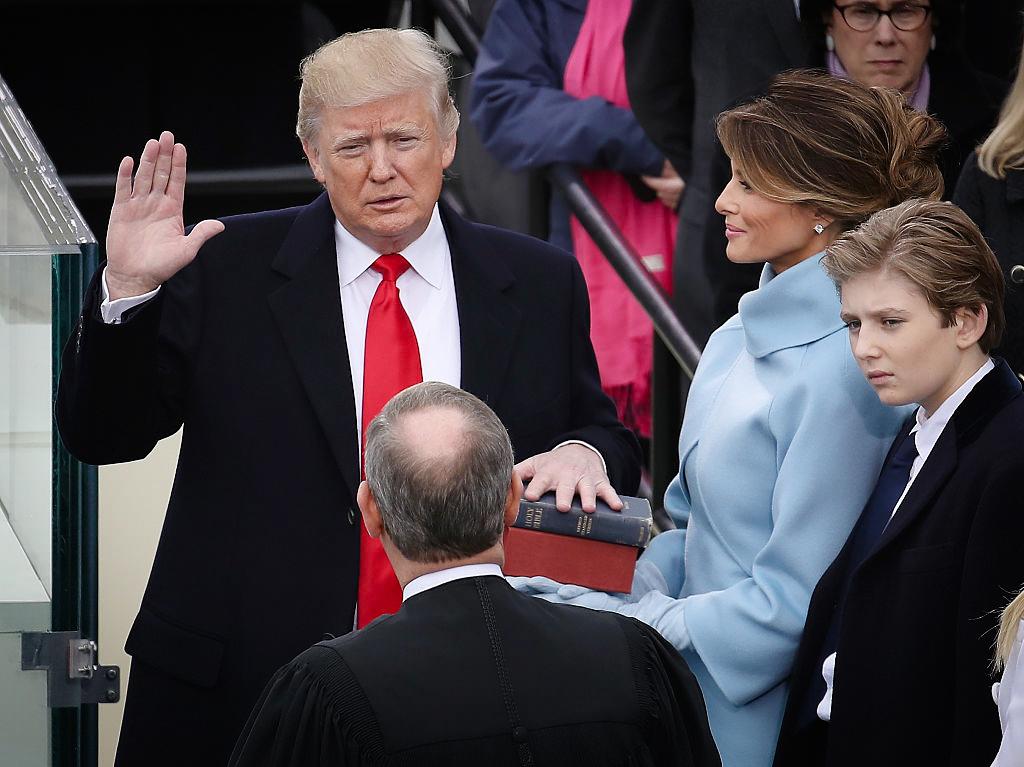 Supreme Court Justice John Roberts (2L) administers the oath of office to U.S. President Donald Trump as his wife Melania Trump holds the Bible and son Barron Trump looks on, at the U.S. Capitol in Washington on Jan. 20, 2017. (Drew Angerer/Getty Images)