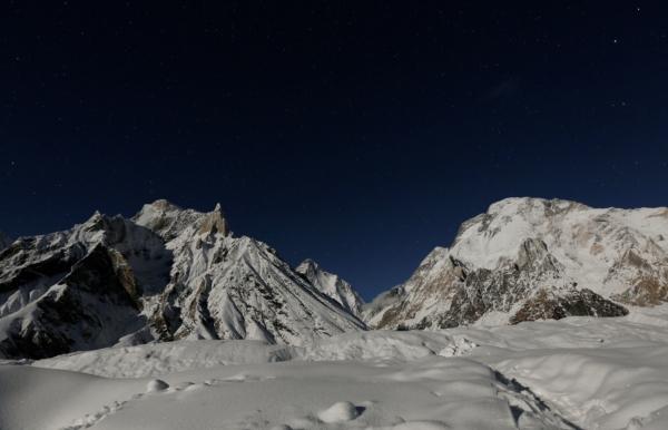 The world's second largest mountain, the 8,611 meter high K2 (seen in the distance), and the 8,051 meter high Broad Peak (R), are illuminated by the moon at Concordia in the Karakoram mountain range in Pakistan, on Sept. 7, 2014. (Wolfgang Rattay/Reuters)