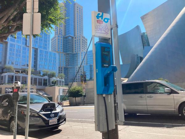 An electric vehicle charges on a publicly accessible pole-mounted charger in Los Angeles on Oct. 4, 2022. (Eugene Garcia/AP Photo)
