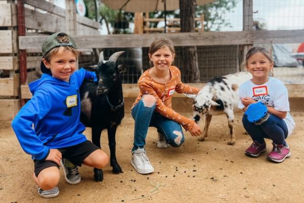 Children interact with baby goats at the farm in San Juan Capistrano, Calif. (Courtesy of Goods and Goats Market)