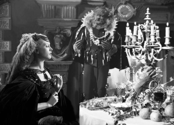 Belle (Josette Day) and Beast (Jean Marais) dine in a magical castle in “Beauty and the Beast.” (MovieStillsDB)