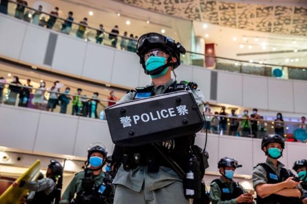 A riot police officer (C) stands guard during a clearance operation during a demonstration in a mall in Hong Kong on July 6, 2020. (Isaac Lawrence/AFP via Getty Images)