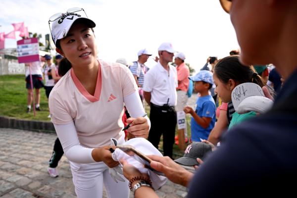 American Rose Zhang of Irvine, Calif., signs memorabilia for spectators after the Second Round of the Amundi Evian Championship at Evian Resort Golf Club in Evian-les-Bains, France, on July 28, 2023. (Stuart Franklin/Getty Images)