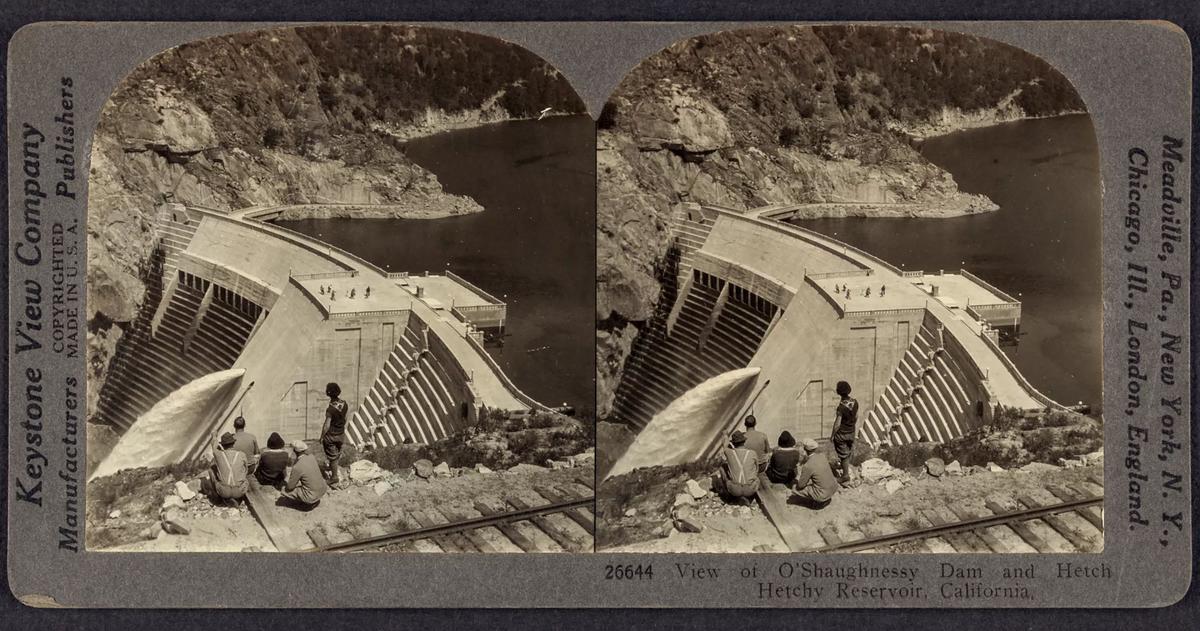 A stereograph from the Keystone View Company, circa 1926, showing a small group of people next to railroad tracks atop a hillside overlooking the O’Shaughnessy Dam and a portion of the Hetch Hetchy Reservoir in California. (Library of Congress, Prints & Photographs Division/TNS)