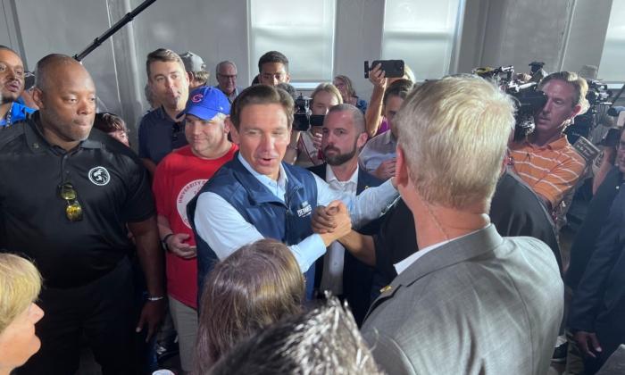 Florida Gov. Ron DeSantis greets supporters at a campaign stop in Chariton, Iowa, on July 27, 2023 (Lawrence Wilson/The Epoch Times)
