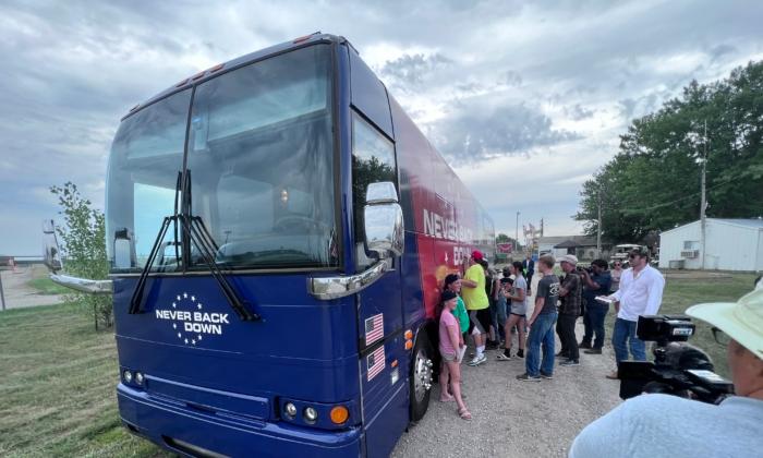 Fairgoers sign Florida Gov. Ron DeSantis's tour bus at the Wayne County, Iowa, fairgrounds, on July 27, 2023. (Lawrence Wilson/The Epoch Times)