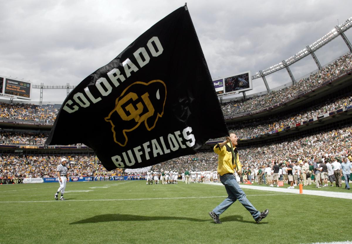An unidentified cheerleader carries the school flag across the end zone to mark a Colorado touchdown in the third quarter in Colorado's 31–28 overtime victory over Colorado State in an NCAA college football game in Denver on Sept. 1, 2007. (David Zalubowski/AP Photo)