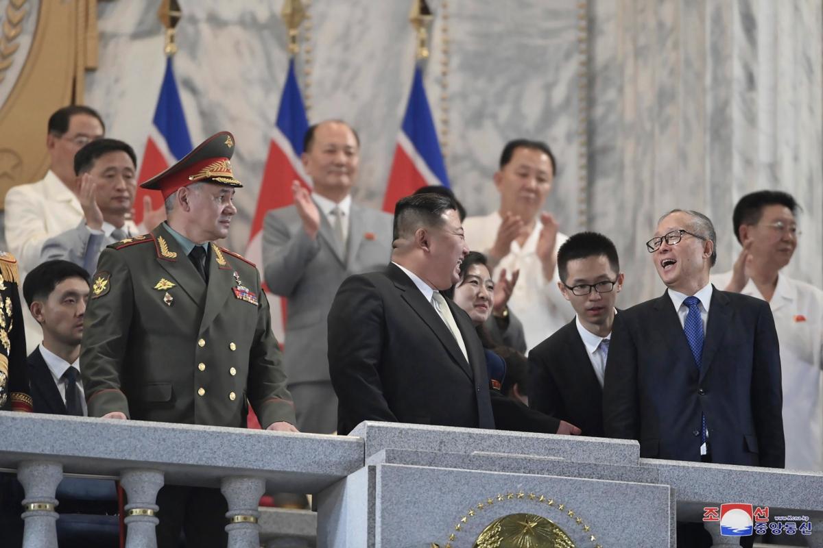  North Korean leader Kim Jong Un (C) talks with Chinese Communist Party Politburo member Li Hongzhong (R) as they and Russian Defense Minister Sergei Shoigu (L) attend a military parade to mark the 70th anniversary of the armistice that halted fighting in the 1950–53 Korean War, on Kim Il Sung Square in Pyongyang, North Korea, on July 27, 2023. (Korean Central News Agency/Korea News Service via AP)