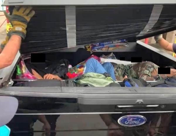 Migrants trapped inside the bed cover of a pickup truck in this 2022 image. (Courtesy of Department of Justice)