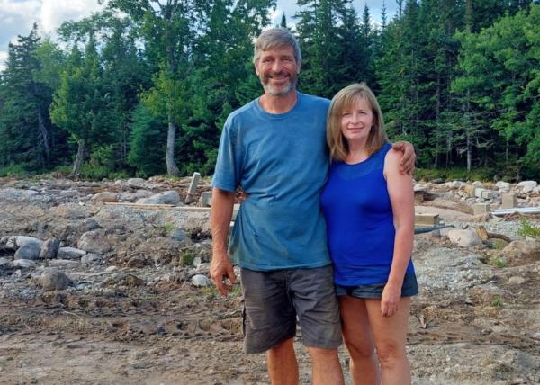Jeff Lear and Nadine Whalen stand on the lot where their home and garden once was, in Lunenburg County, N.S., on July 31, 2023. Flash flooding on July 21 and 23 destroyed it all. (Courtesy of Nadine Whalen)