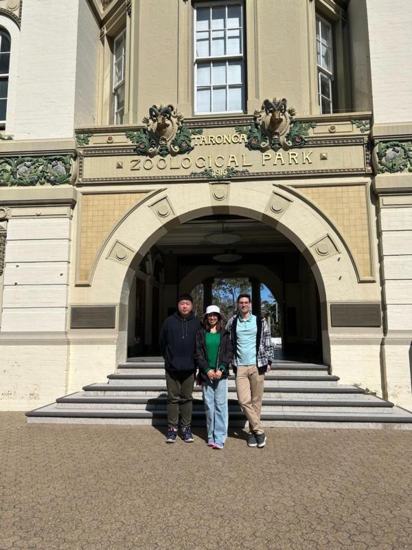 Allen Wang with his sister and brother-in-law posed in front of the Taronga Zoological Park in Sydney. (Courtesy of Cathy Wang)