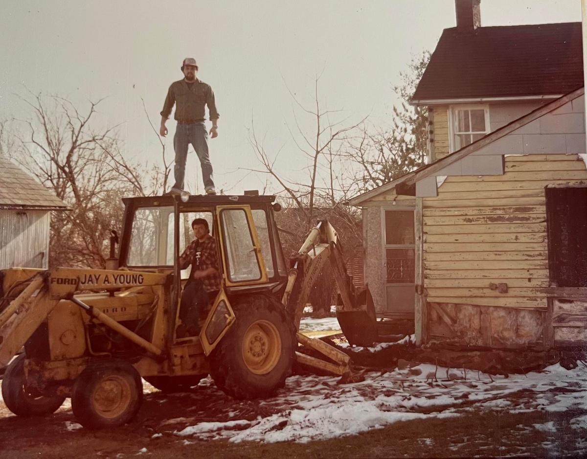 Mr. Simpson is shown in an excavator during demolition of a preexisting kitchen in the house in 1984. (Courtesy of Ronnie Simpson)