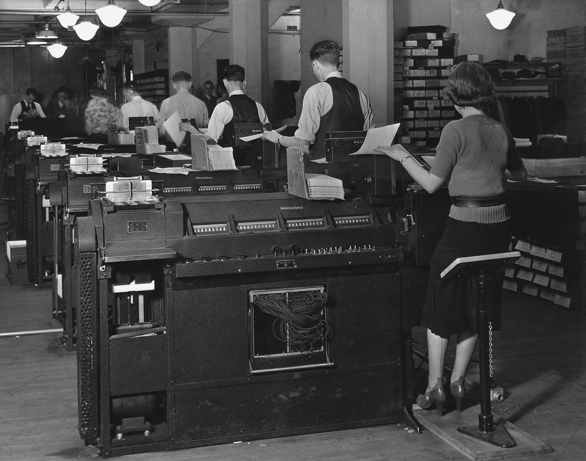 Social Security Administration clerks seated at massive tabulating machines, early computers used to manage individual records of millions of Americans in the Social Security system. Ca. 1940. (Everett Collection)