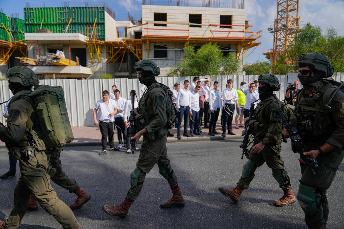 Israeli security forces are deployed at the site of a shooting attack in the West Bank Israeli settlement of Ma'ale Adumim on Aug. 1, 2023. (Ohad Zwigenberg/AP Photo)