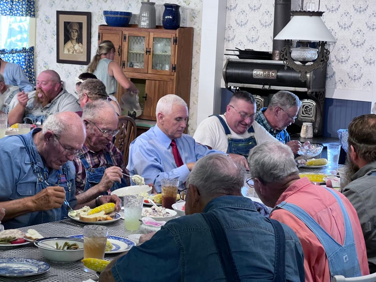 Former Vice President Mike Pence (center) has lunch with farmers at the Indiana State Fairgrounds in Indianapolis on Aug. 2, 2022. (Lawrence Wilson / The Epoch Times)