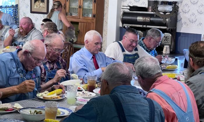 Former Vice President Mike Pence (C.) eats lunch with farmers at the Indiana State Fair in Indianapolis on Aug. 2, 2023. (Lawrence Wilson/The Epoch Times)