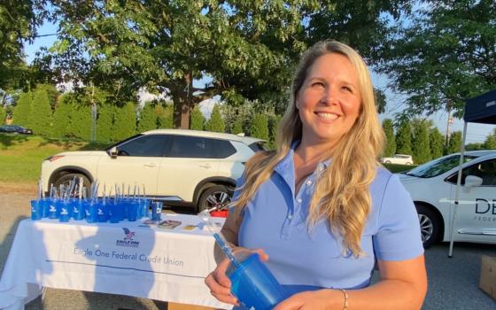 Kristina Balun, marketing director and HR coordinator of Eagle One Federal Credit Union, had a table at National Night Out in Newark on Aug. 1, 2023. (Lily Sun/The Epoch Times)