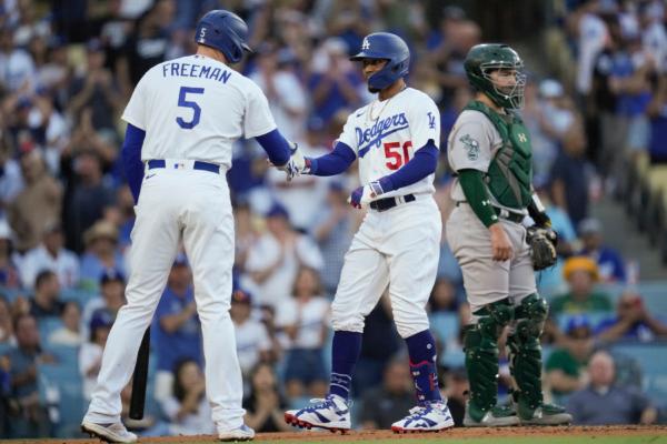 Los Angeles Dodgers' Mookie Betts (50) celebrates with Freddie Freeman (5) after hitting a home run during the second inning of a baseball game against the Oakland Athletics in Los Angeles on Aug. 2, 2023. (Ashley Landis/AP Photo)