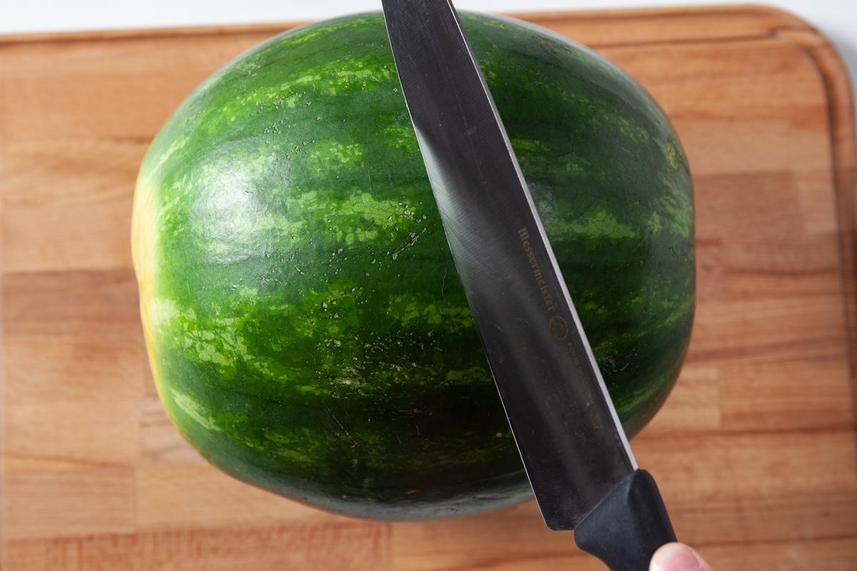 Start by slicing watermelon in half, taking care not to let it split. (Courtesy of Amy Dong)