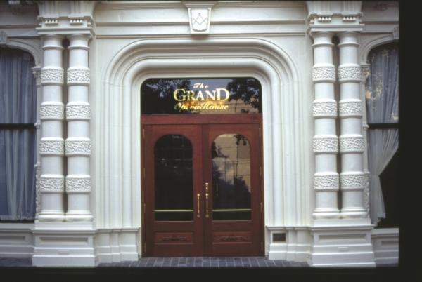 The main entryway of the Grand Opera House evokes a bygone era with decorative solid wood doors featuring its name etched into the glass, as well as highly distinct, painted cast-iron double columns. (Courtesy of TheGrandWilmington)