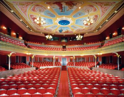 What performers view from the stage is a treat for the eyes: seating for 1,208 patrons, slender decorative columns supporting a lavish second-tier railing, and a richly hued and impressively painted ceiling. (Courtesy of TheGrandWilmington)