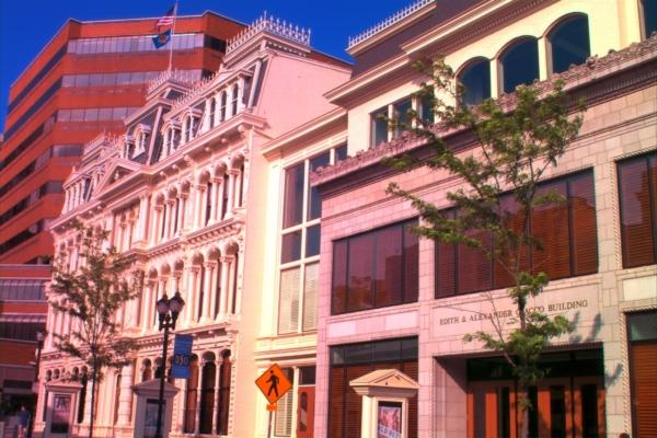Juxtaposed with modern architecture, the Grand Opera House displays impressive ornamentation with its classical-style pediments and corbels, all crafted by hand. The contrast of the clean-lined contemporary buildings surrounding it further help to make it a stand out on Market Street in Wilmington, Delaware. (Courtesy of TheGrandWilmington)