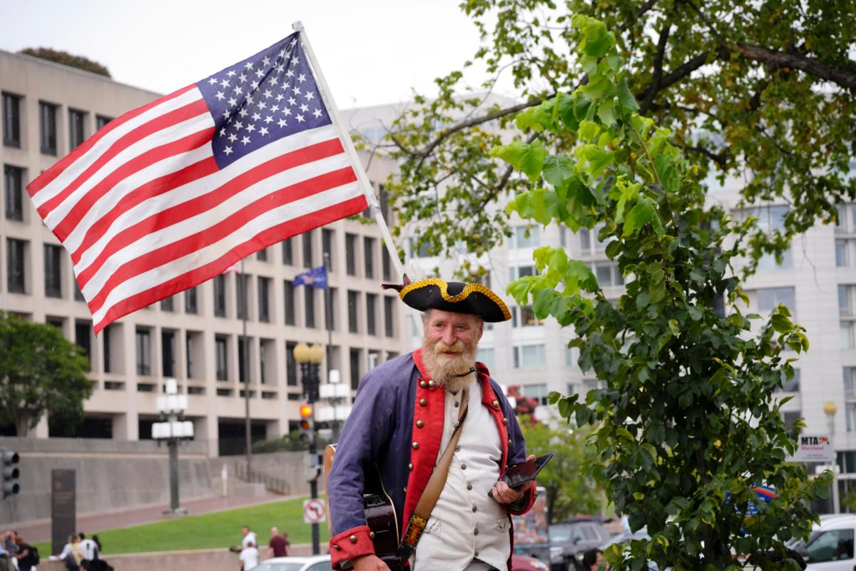 A protester in an American War of Independence uniform at the E. Barrett Prettyman federal courthouse after former President Donald Trump was arraigned on Jan. 6 charges in Washington on Aug. 3, 2023. (Madalina Vasiliu/The Epoch Times)