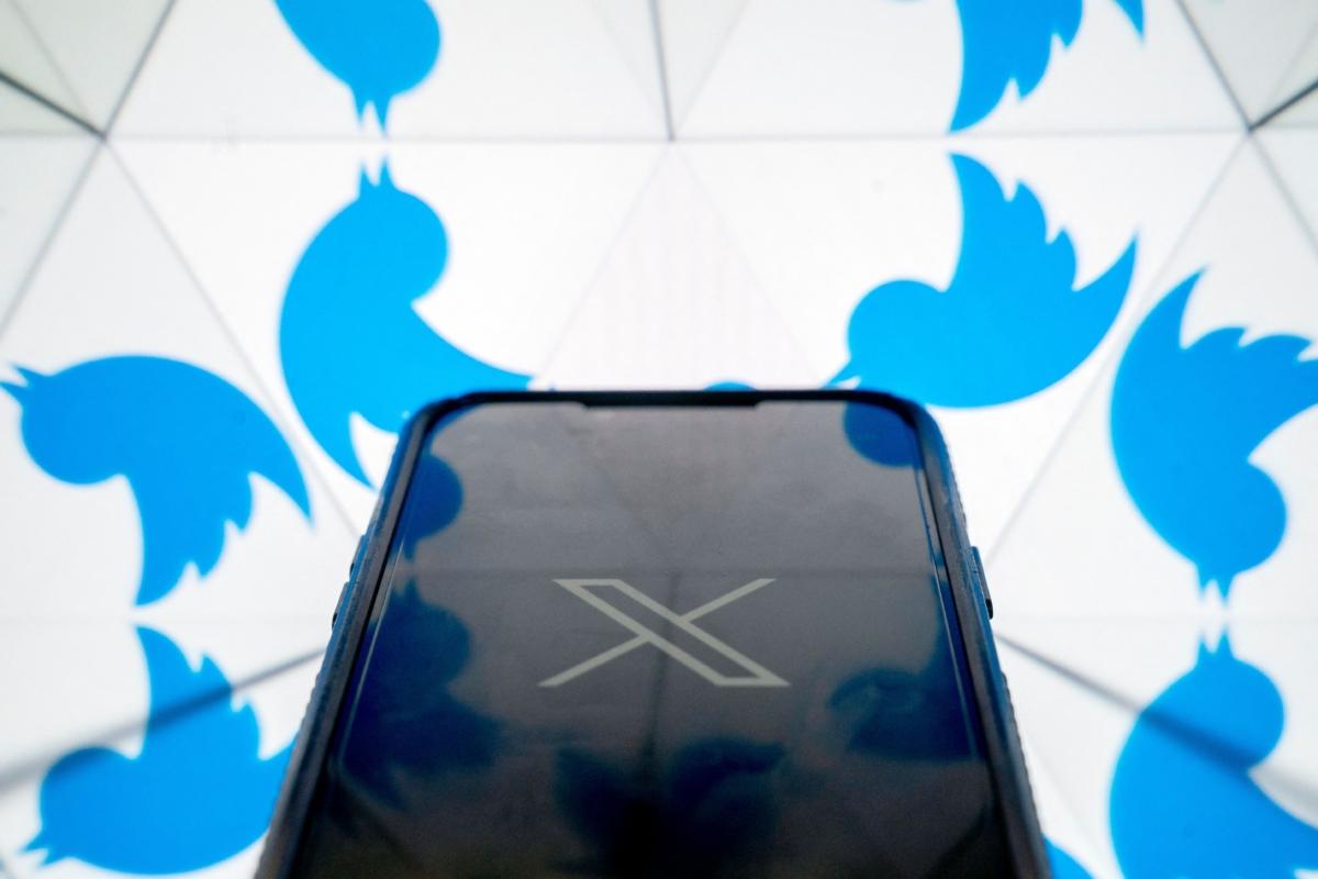 The new X logo in front of the bird Twitter logo in Washington on July 24, 2023. (Stefani Reynolds/AFP via Getty Images)