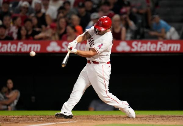 Mike Moustakas (8) of the Los Angeles Angels hits an RBI double to score C.J. Cron (25) during the sixth inning against the Seattle Mariners at Angel Stadium of Anaheim in Anaheim, Calif., on August 3, 2023. (Kevork Djansezian/Getty Images)