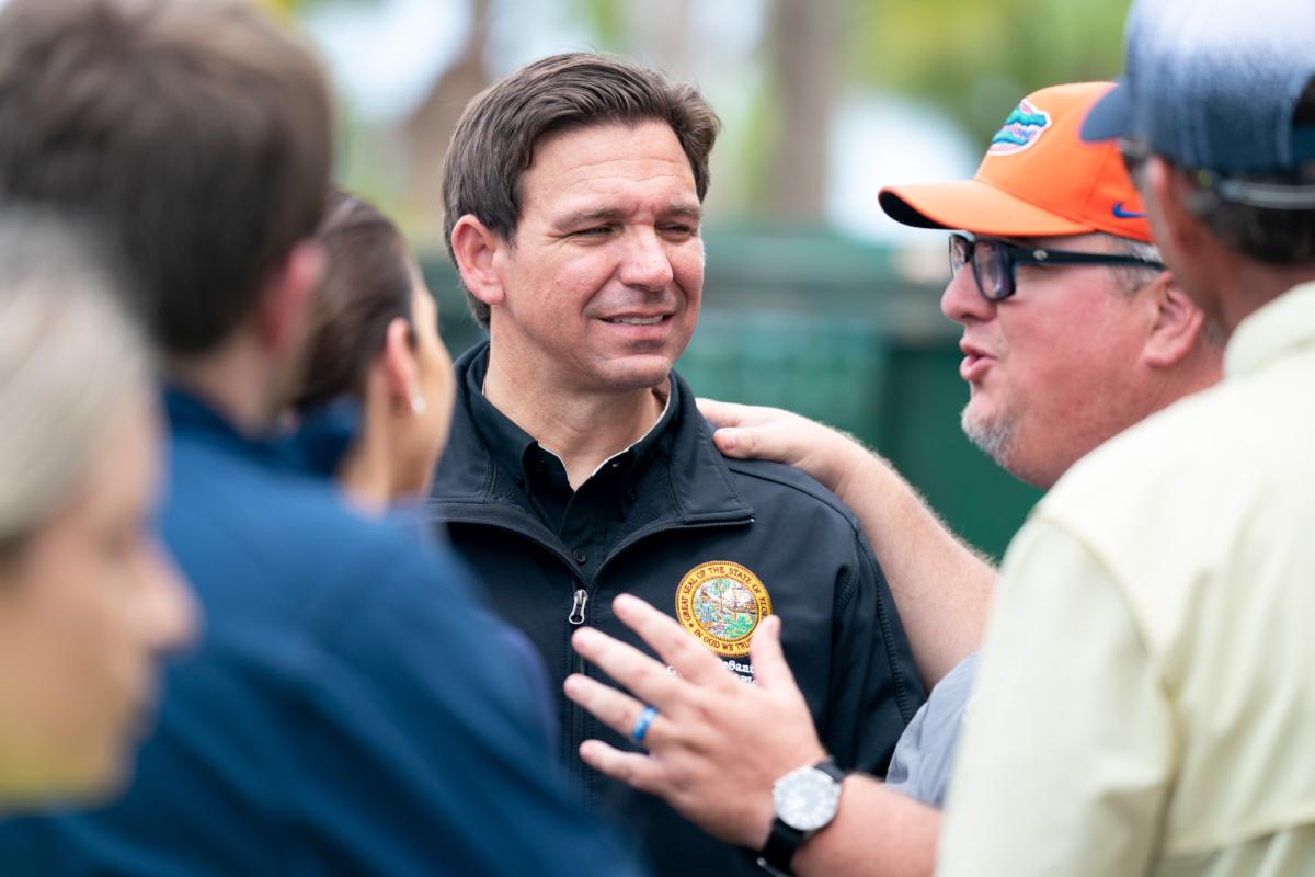 Florida Gov. Ron DeSantis (2nd L) talks with people before a press conference in the aftermath of Hurricane Idalia, in Steinhatchee, Fla., on Aug. 31, 2023. (Sean Rayford/Getty Images)