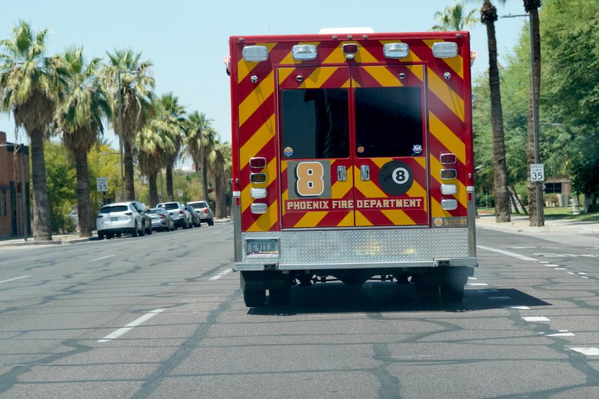 A Phoenix, Ariz., Fire Department ambulance with red lights flashing during 109-degree temperatures on Aug. 3, 2023. (Allan Stein/The Epoch Times)