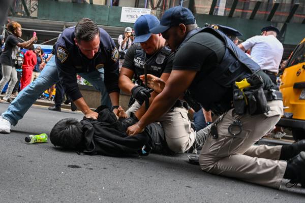 Members of the NYPD arrest people after responding to thousands of people gathered for a "giveaway" event announced by popular Twitch live streamer Kai Cenat in Union Square and the surrounding area in New York City, on Aug. 4, 2023. (Alexi J. Rosenfeld/Getty Images)