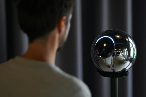 Ricardo Macieira, regional manager, Europe stands to simulate the iris scan near the biometric imaging device, the Orb, of the identity and financial utility Worldcoin, aiming to create a World ID digital passport, being able to trade in cryptocurrency, in Berlin, on Aug. 1, 2023. (Annegret Hilse/Reuters)
