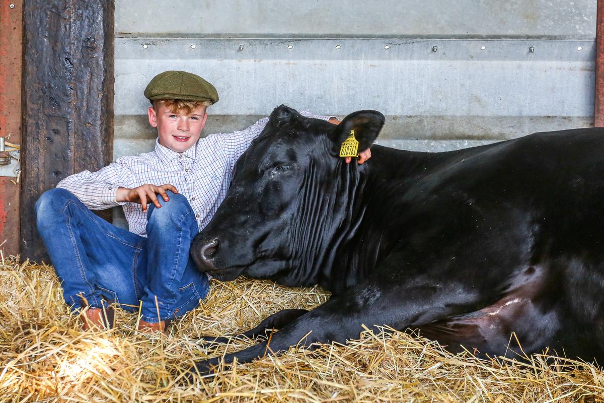 Joe Trofer on his farm in Lincolnshire with his cow, Rosie. (SWNS)