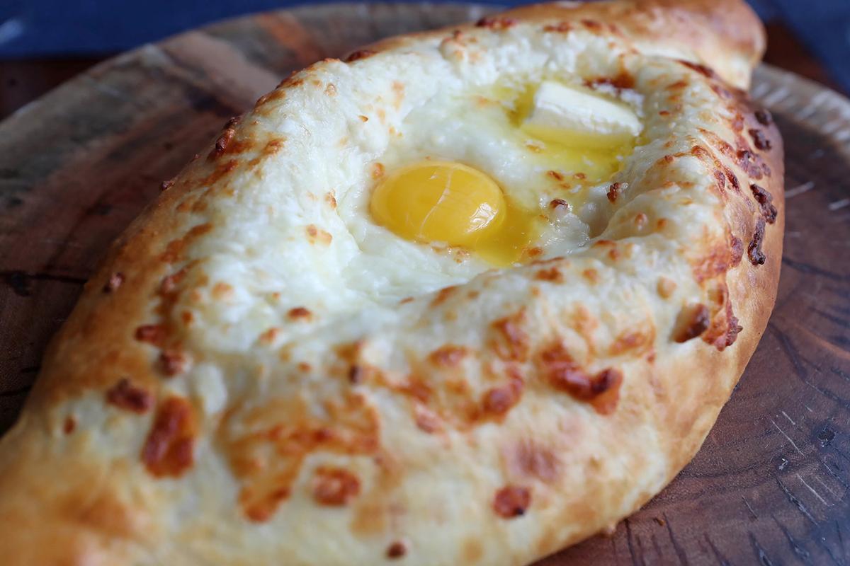 Adjarian khachapuri, a bulging flatbread shaped like a dugout canoe, is a signature dish at Askaneli, a Georgian restaurant in downtown Fort Lauderdale. (John McCall/Sun Sentinel/TNS)