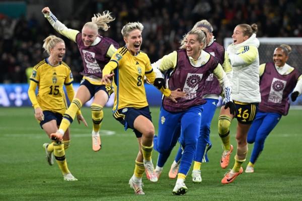 Sweden's Lina Hurtig (8) leads a celebration following scoring the final penalty shot over team USA at the Australia and New Zealand 2023 Women's World Cup round of 16 soccer match at Melbourne Rectangular Stadium in Melbourne, Australia, on Aug. 6, 2023. (William West/AFP via Getty Images)