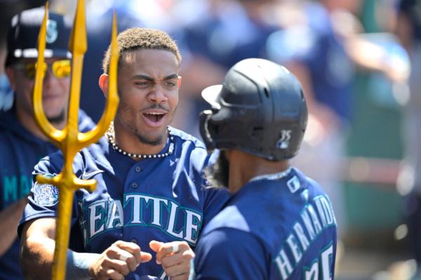 Teoscar Hernandez (35) of the Seattle Mariners is congratulated by Julio Rodriguez (44) in the dugout after hitting a solo home run in the seventh inning against the Los Angeles Angels at Angel Stadium of Anaheim in Anaheim, Calif., on August 6, 2023. (Jayne Kamin-Oncea/Getty Images)