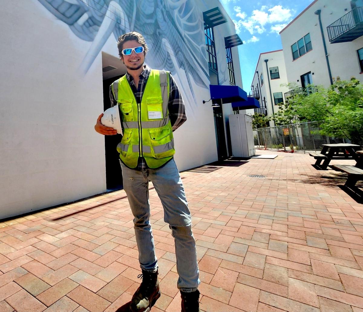 Anders Engnell, construction manager for Culdesac Tempe, a "walkable" community in Tempe, Ariz., where cars are not allowed, stands in front of a building under construction on Aug. 2, 2023. (Allan Stein/The Epoch Times)