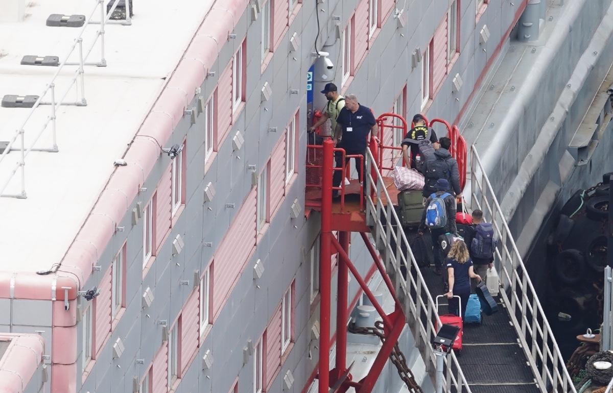 People boarding the Bibby Stockholm accommodation barge at Portland Port in Dorset, England, on Aug. 7, 2023. (PA)
